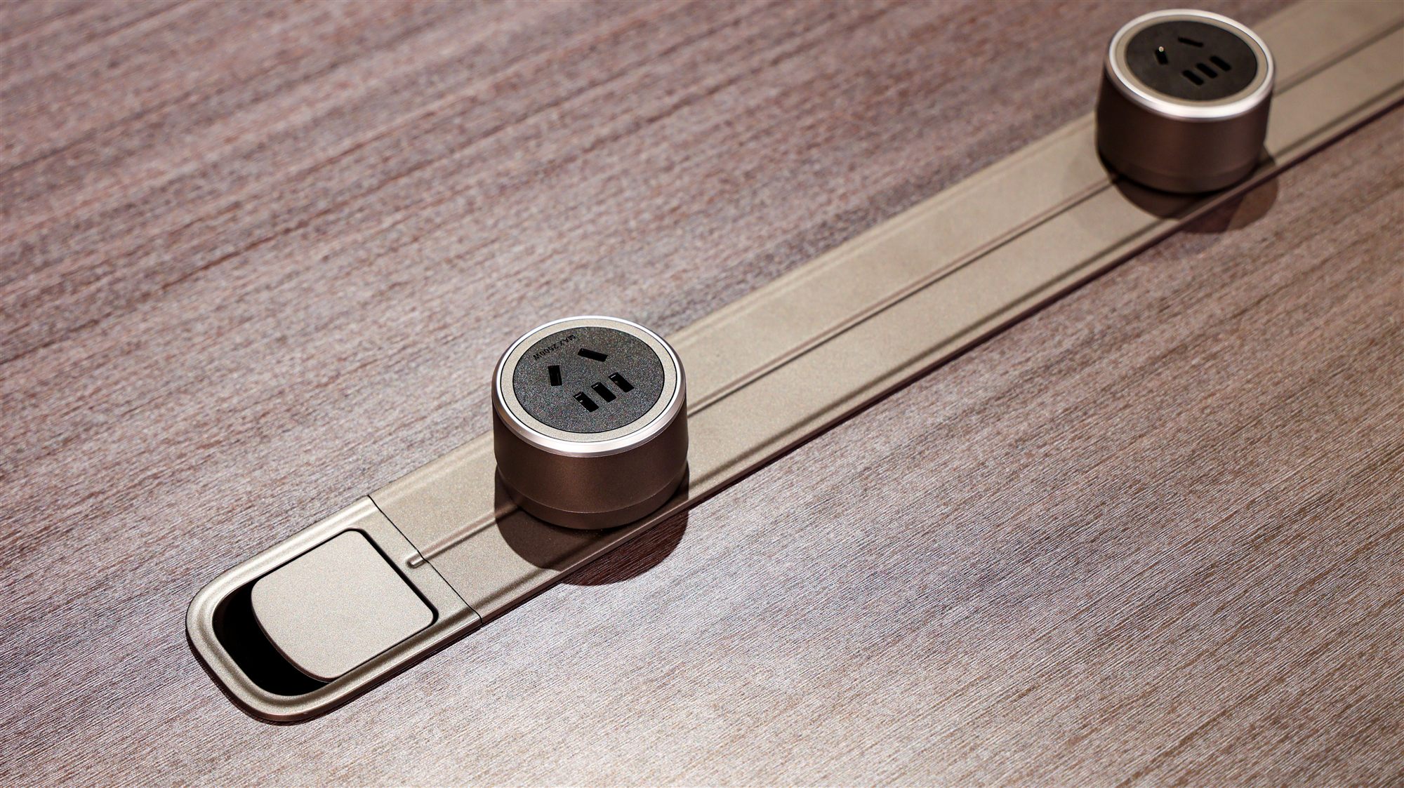 Desk-top power module set into a walnut veneer surface